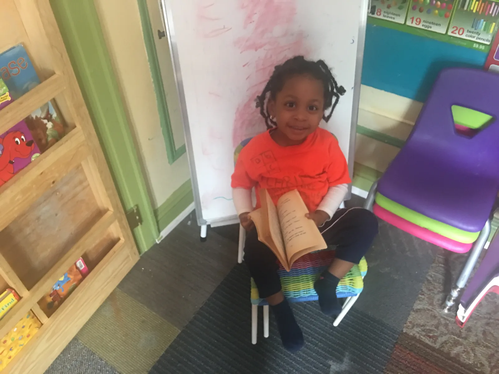 Child reading a book in the daycare
