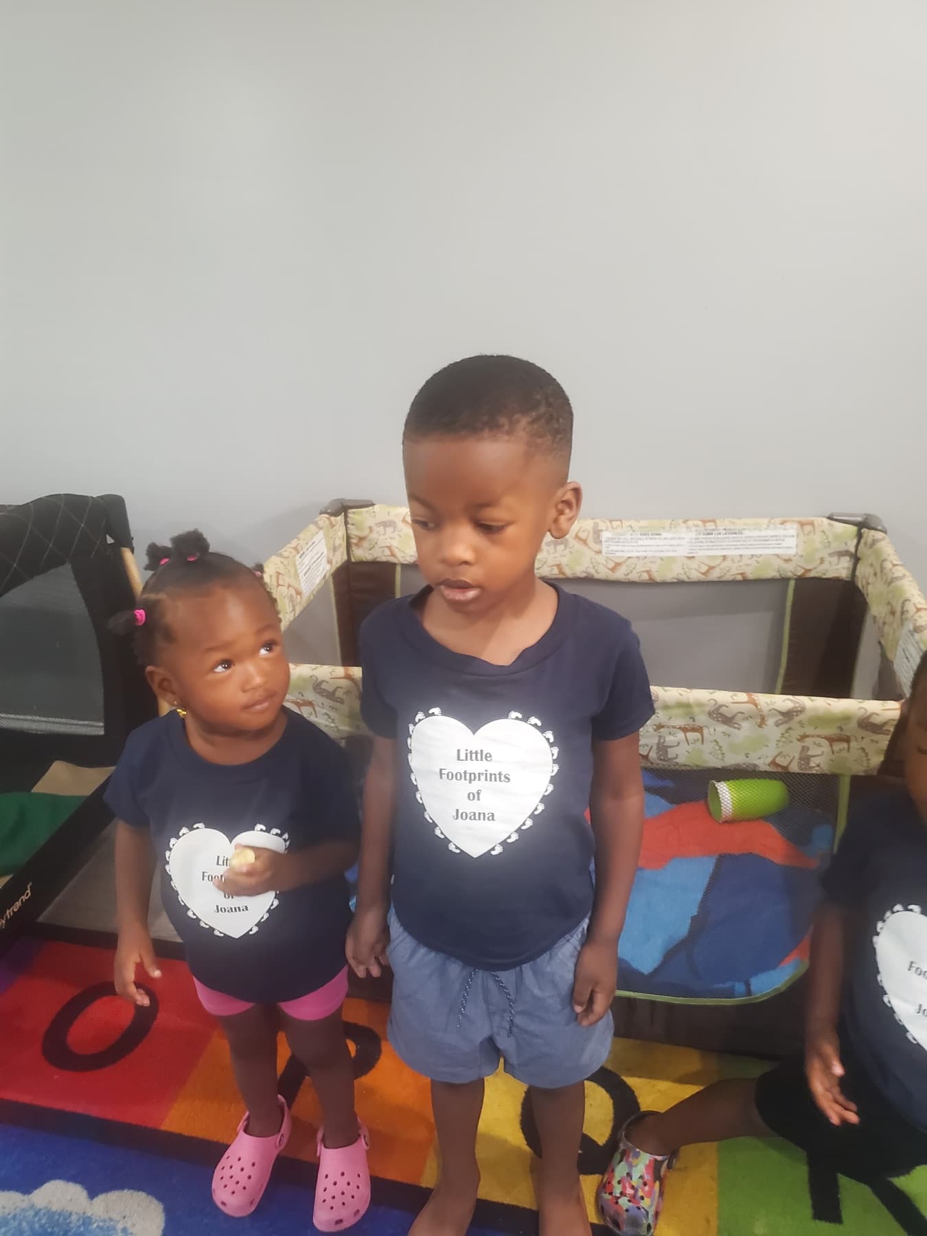 Children wearing Little Footprints daycare shirts