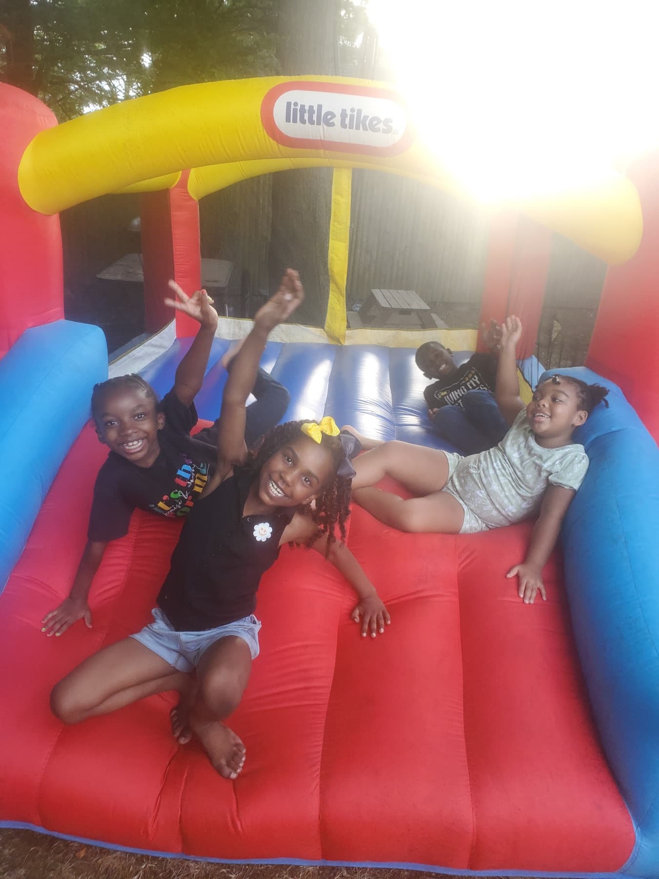 Children smiling together during outdoor bounce play