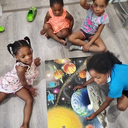 Children exploring a space-themed learning activity