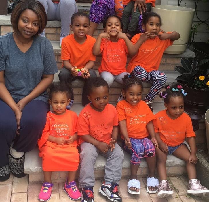 Children and caregivers outside the daycare