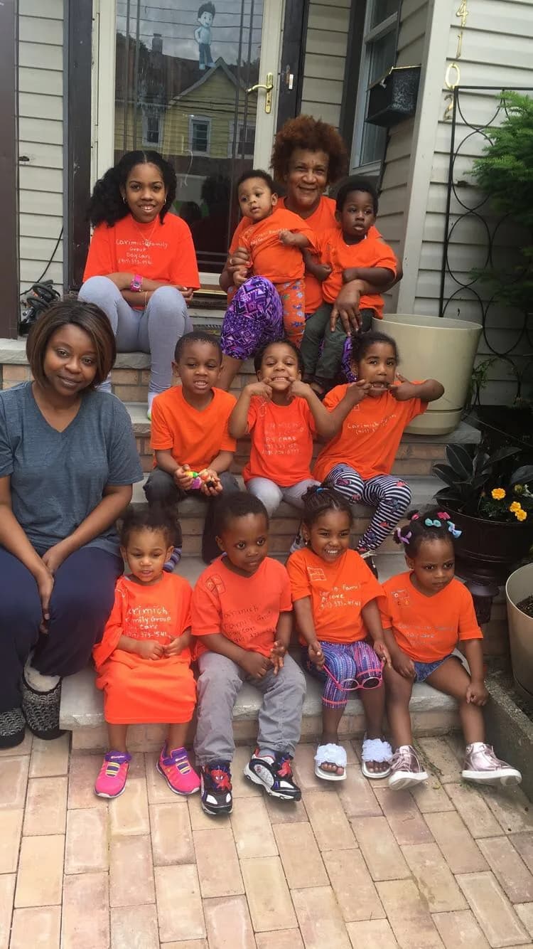 Children and caregiver gathered outside the daycare