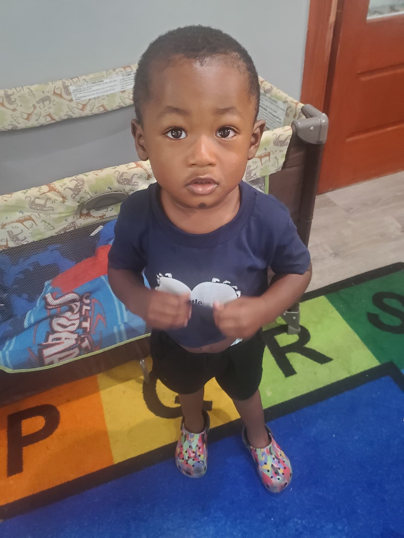 Child wearing a Little Footprints daycare shirt