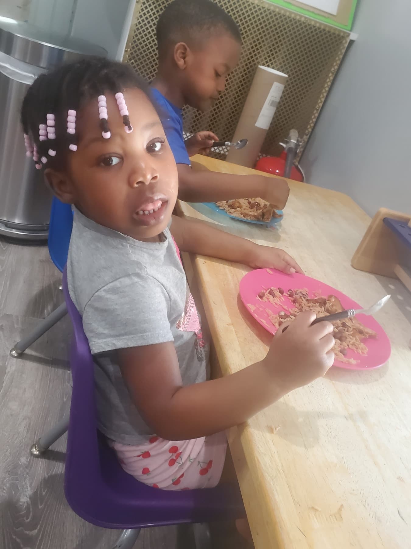Children eating lunch together at the daycare table