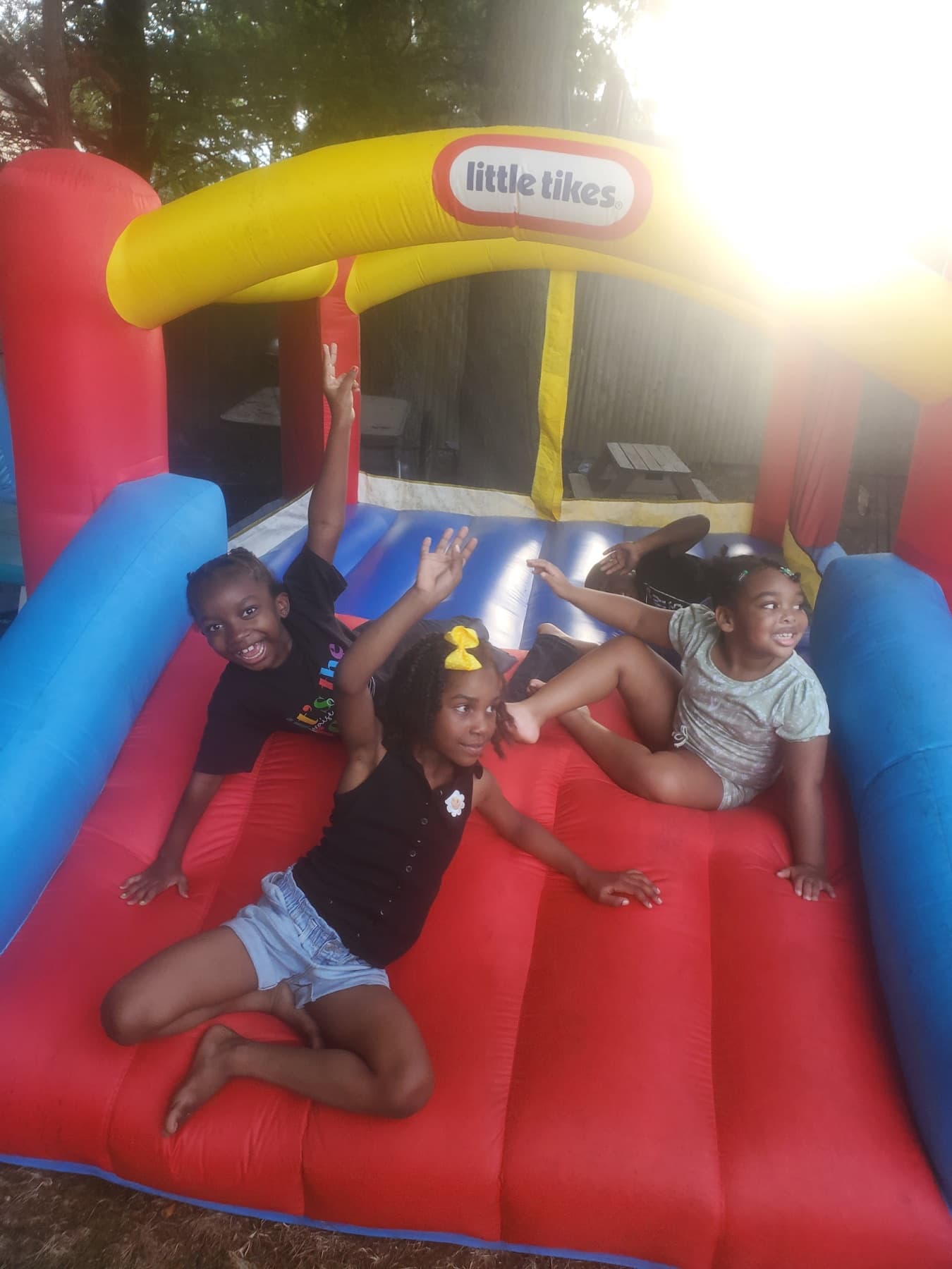 Children playing together on a backyard bounce house