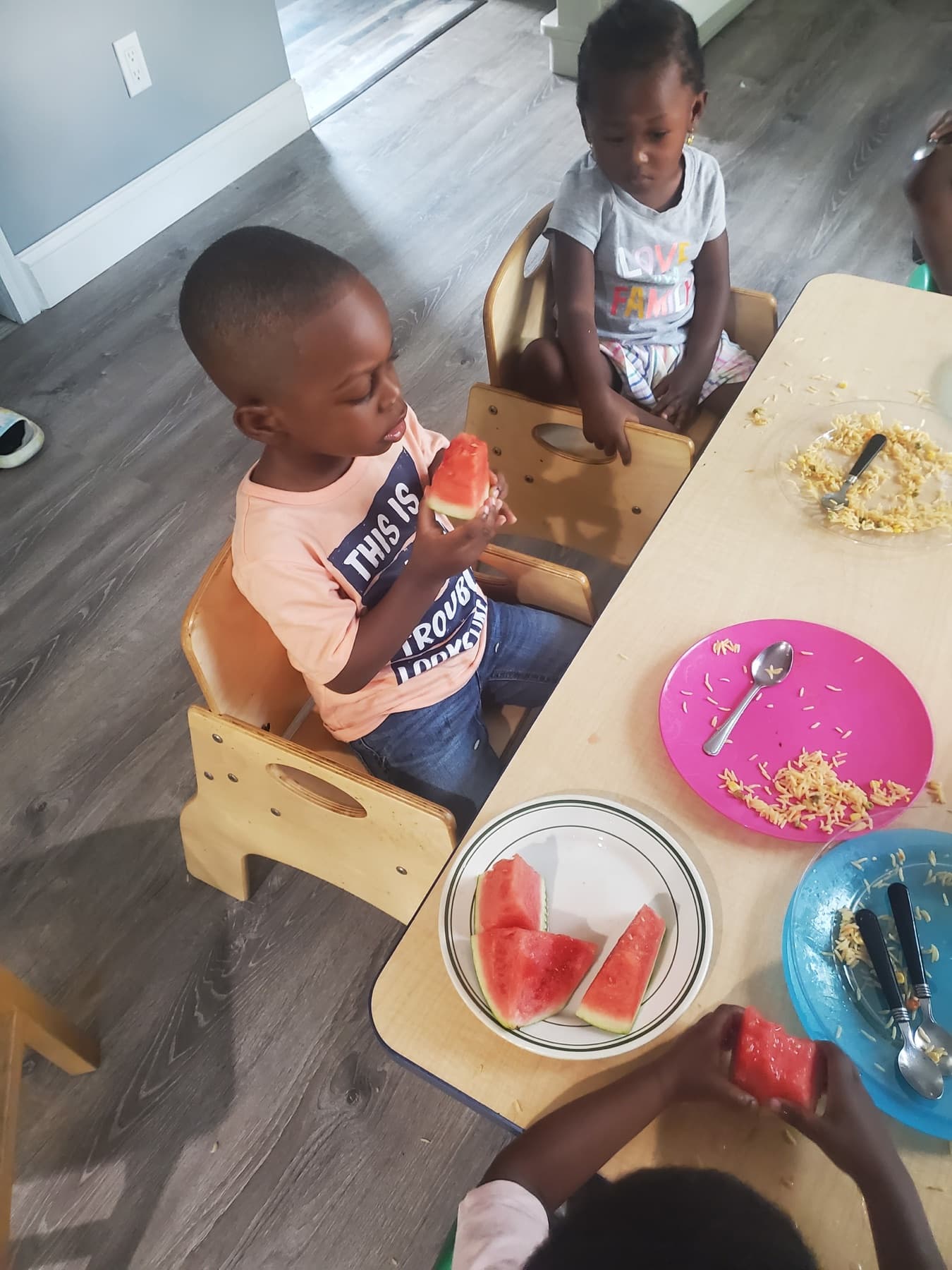 Children enjoying watermelon during snack time