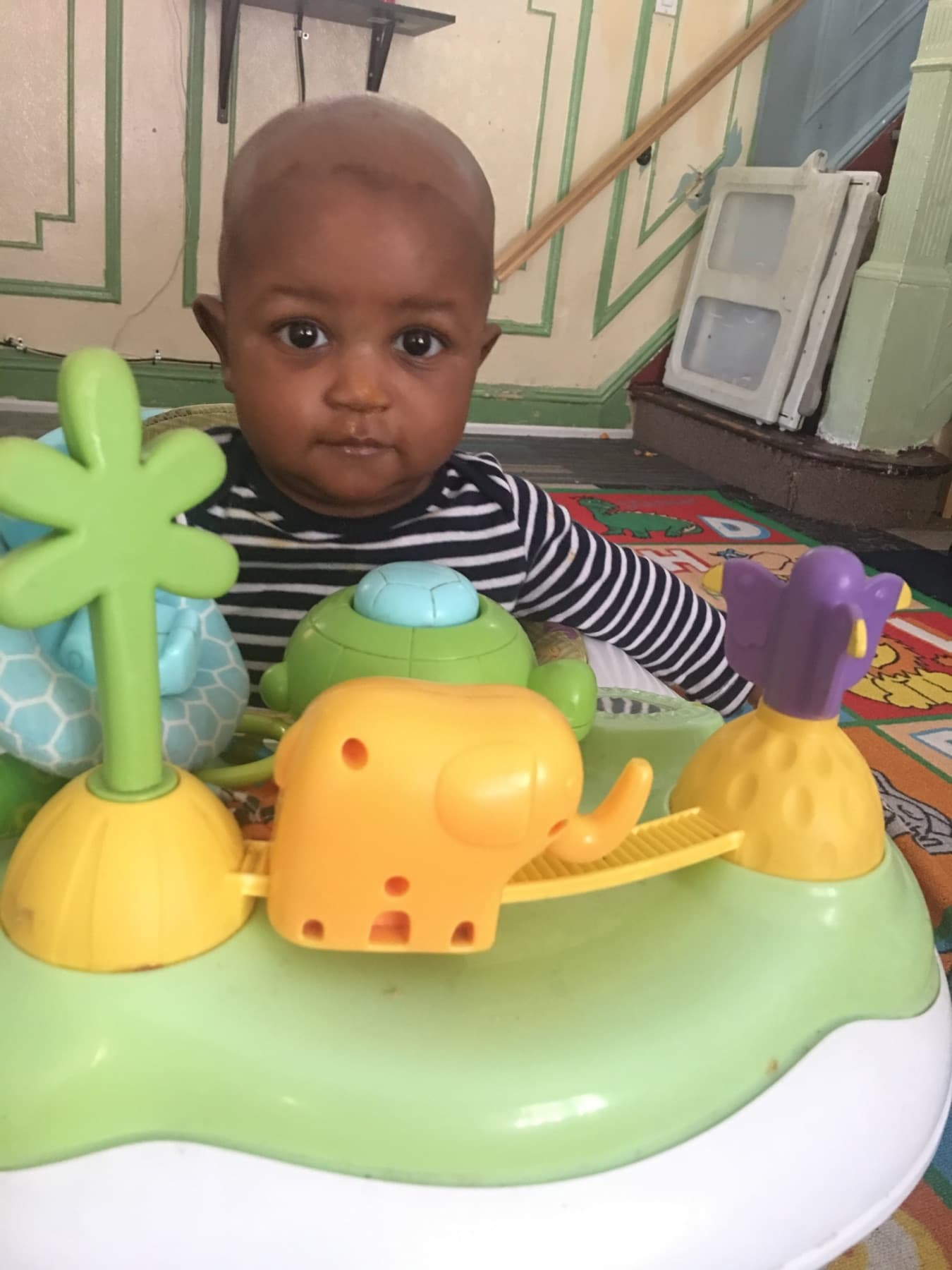 Infant exploring a colorful activity toy
