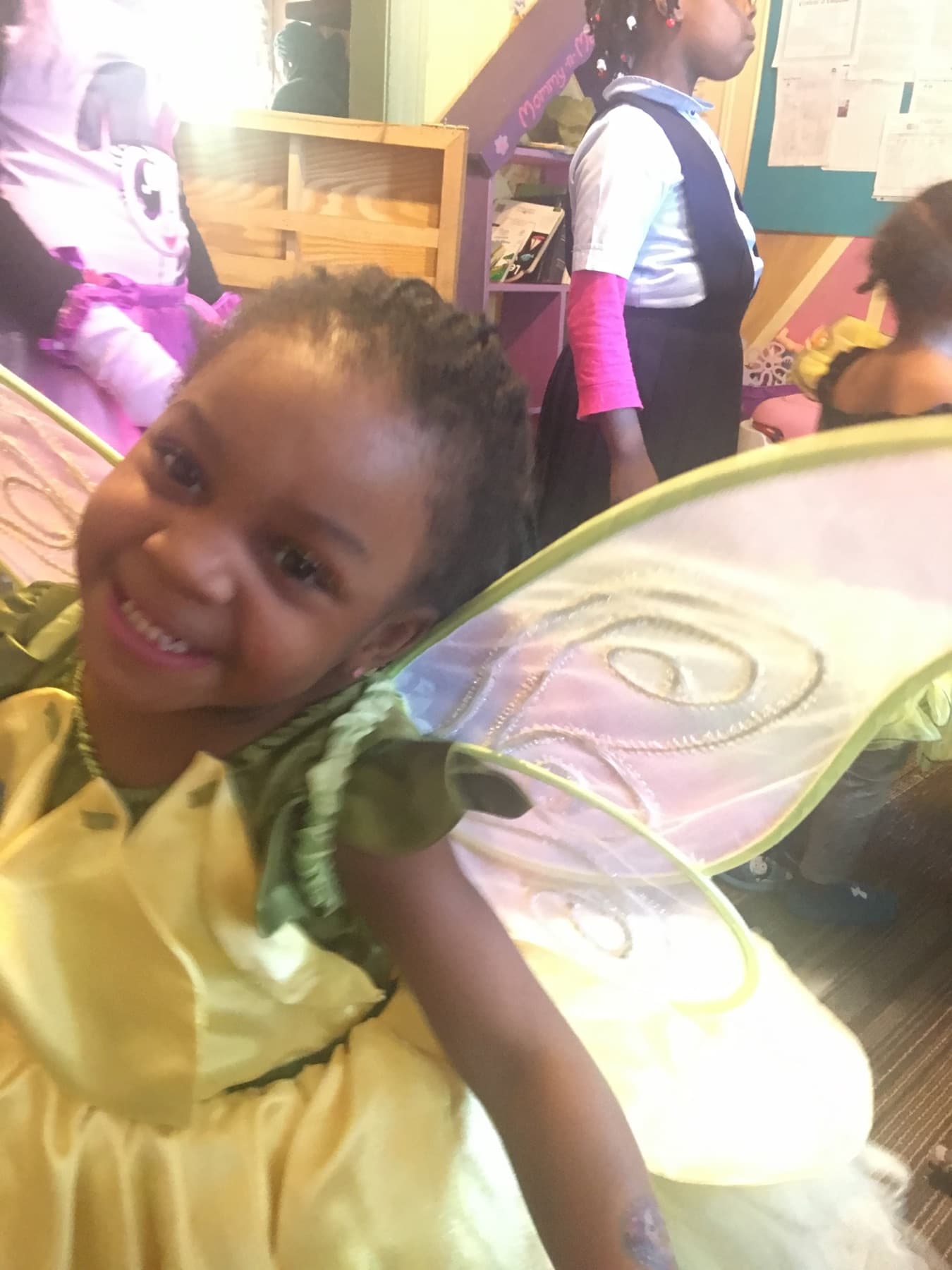 Child smiling in costume during daycare dress-up day