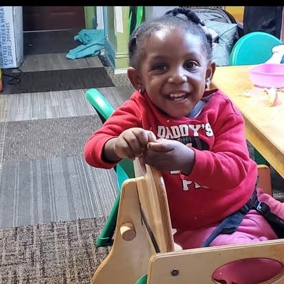 Child smiling during a classroom activity