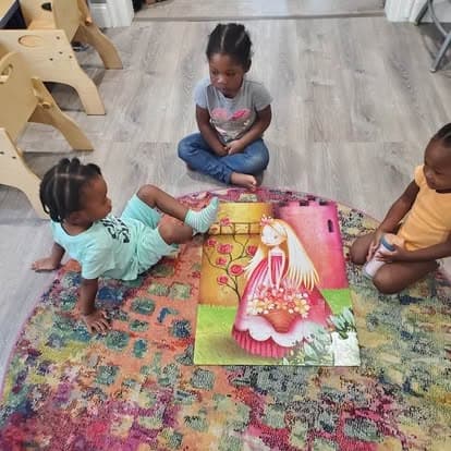 Children seated around a story mat